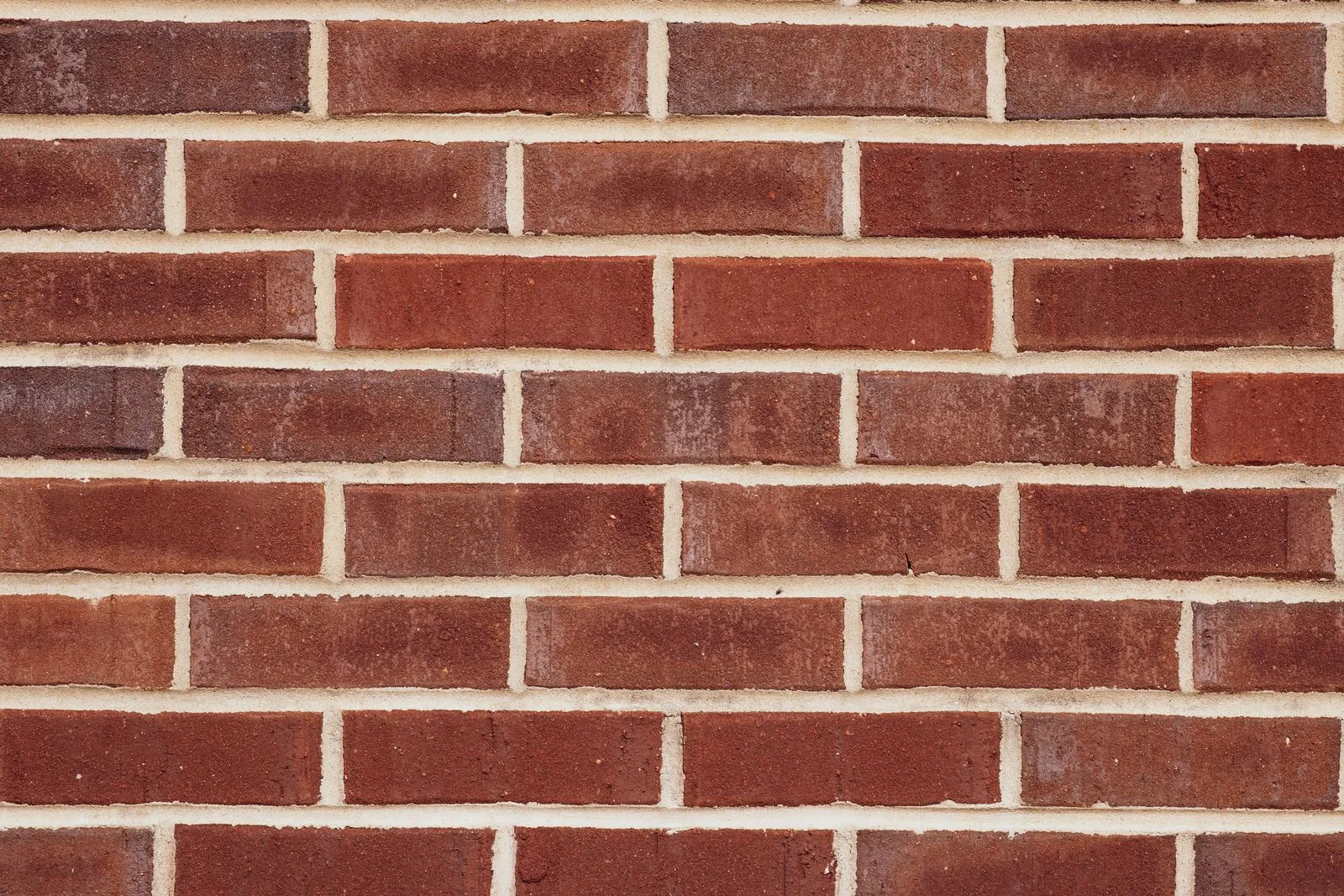 Close-up of a red brick wall, showing texture and pattern, ideal for backgrounds.